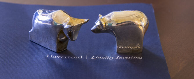 Haverford Trust branded materials on a desk including a folder, brochure, small bull and bear figurines
